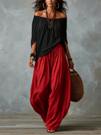 Ensemble haut noir à épaules dénudées et pantalon lanterne ample rouge